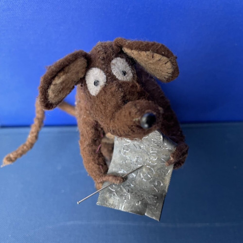 Photo of Minimus the Latin mouse with a little lead tablet inscribed with the message "To the God Aristaeus I dedicate the thief who stole my cheese".