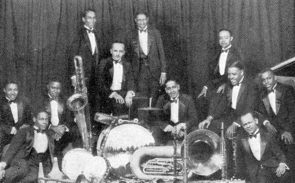 Henderson (middle) with his orchestra in 1925. Coleman Hawkins is sitting on the floor to the extreme left with Louis Armstrong above him to the right. Don Redman is at the extreme right.