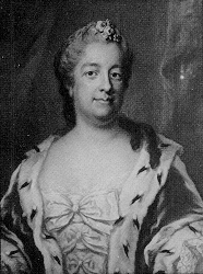 Black and white copy of a color painted portrait of a woman who looks right at the viewer. She wears a furred dressed with satin bows down the front. Her hair is pulled back and she has two curls over her left shoulder.