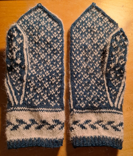 Inside of hand-knitted mittens, blue and white coliurwork pattern