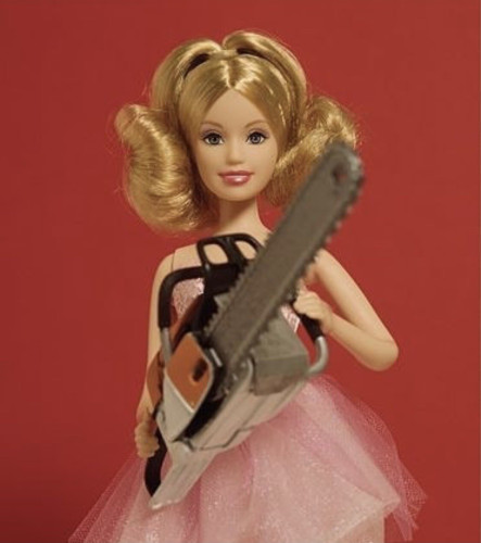 Barbie doll in a pink dress with a chainsaw in hand.

© David Levinthal