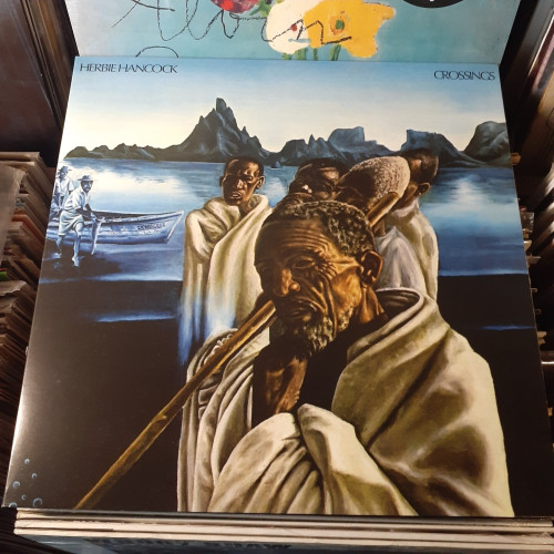 Album cover features a painting of elderly African men on a boat.  They're looking at something, somewhat quizzically.