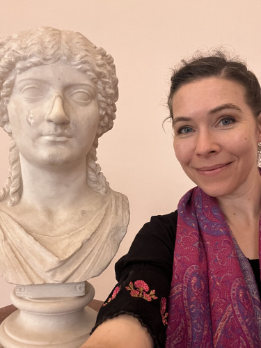 Dr G standing next to a bust of Agrippina while taking a selfie.