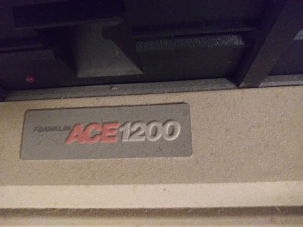 Photo: Dusty nameplate on a Franklin Ace1200 computer.
