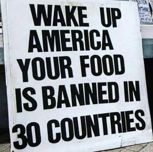 Letter sign that reads: wake up America your food is banned in 30 countries.