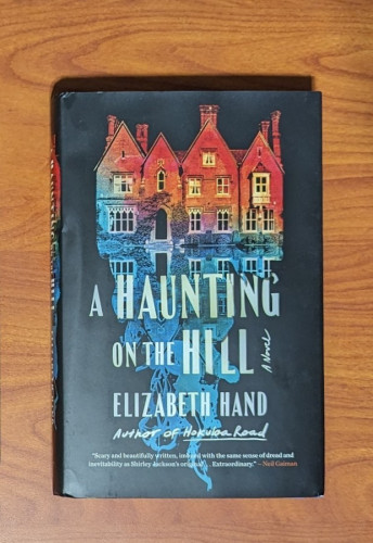 Cover of A HAUNTING ON THE HILL by Elizabeth Hand. A facade of a house is shown in red and blue.
