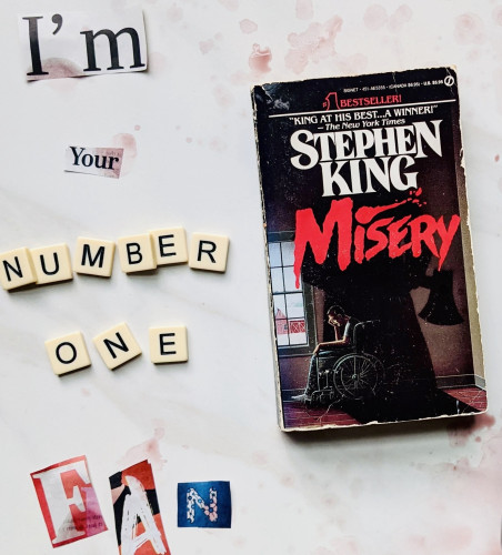 Spelled out in different letter, “I’m your number one fan.” The book, Misery by Stephen King is off to the right.