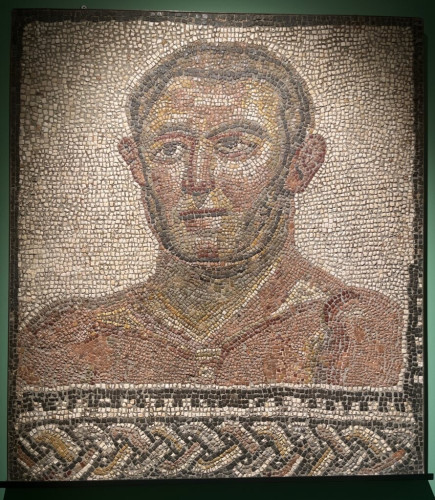 Portrait mosaic of a male athlete. His head and bust are captured with a braided border style at the bottom. His expression is rather serious.
