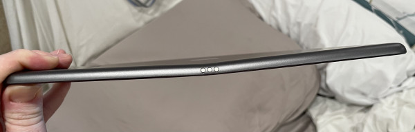An iPad 13 viewed from the edge. The screen is bent about 5° from straight, right at the center.